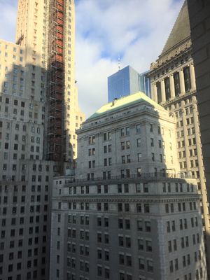 Here's the view from my apartment - you can see the Freedom Tower spire in the middle background.&nbsp; The white building in front is the New York Stock Exchange and the building with the construction elevator on it is 1 Wall Street, a 1931 Art Deco building that used to be a bank headquarters but is being converted to condos.