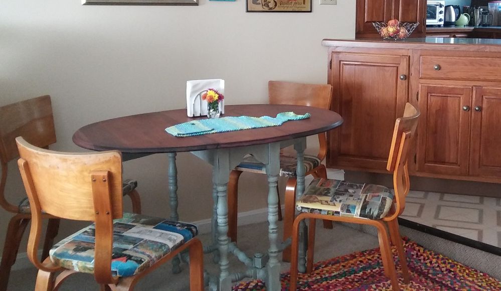 Refinished & painted the table & did chair seats w/collage of vintage Mystic images. (chairs are from my grandma's. :)) Also knitted the whale table runner.