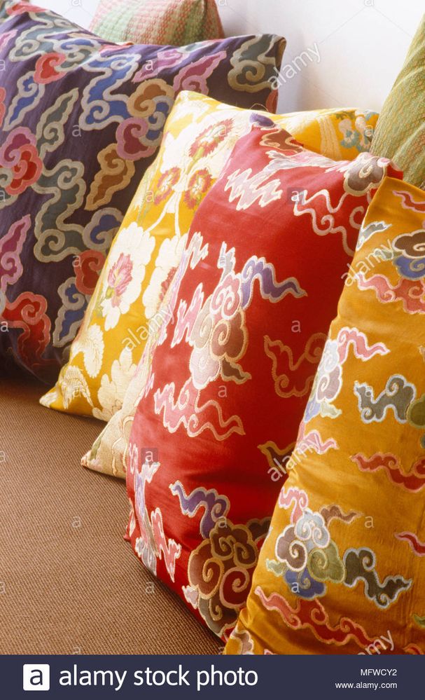 brightly-coloured-patterned-cushions-in-a-row-MFWCY2.jpg