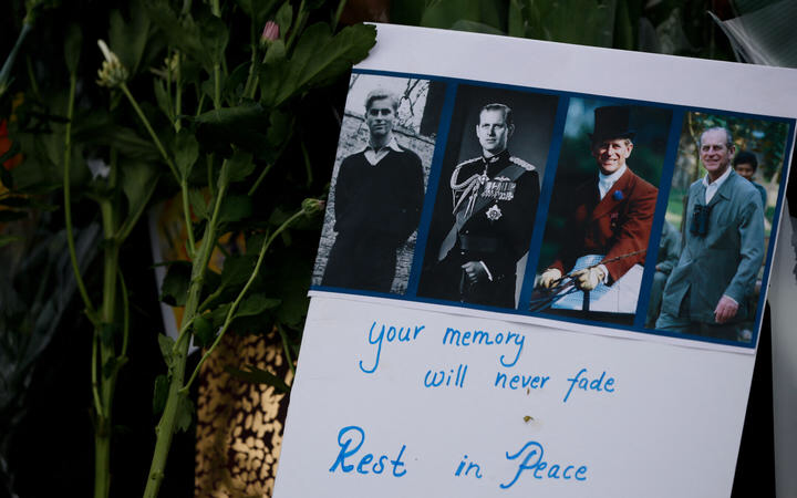 A tribute message for Prince Philip amid flowers outside Buckingham Palace.