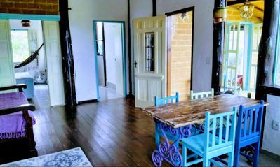 ntegrated spaces where ventilation and light roam free. An old farmhouse door makes a nice table top. Another antique door style from the 1940s stands proud at the entrance.